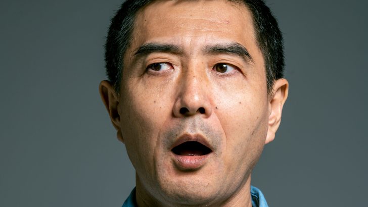 Man in blue button up shirt astonished