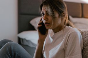 A woman in white shirt calling on her cellphone